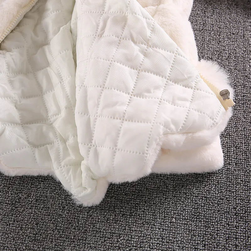 Studio shot of a girls' white faux fur winter princess jacket, clear detail, baby clothing