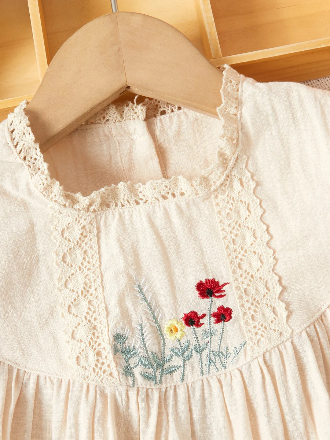 Knee-length girls' summer dress featuring beautiful floral embroidery pattern
