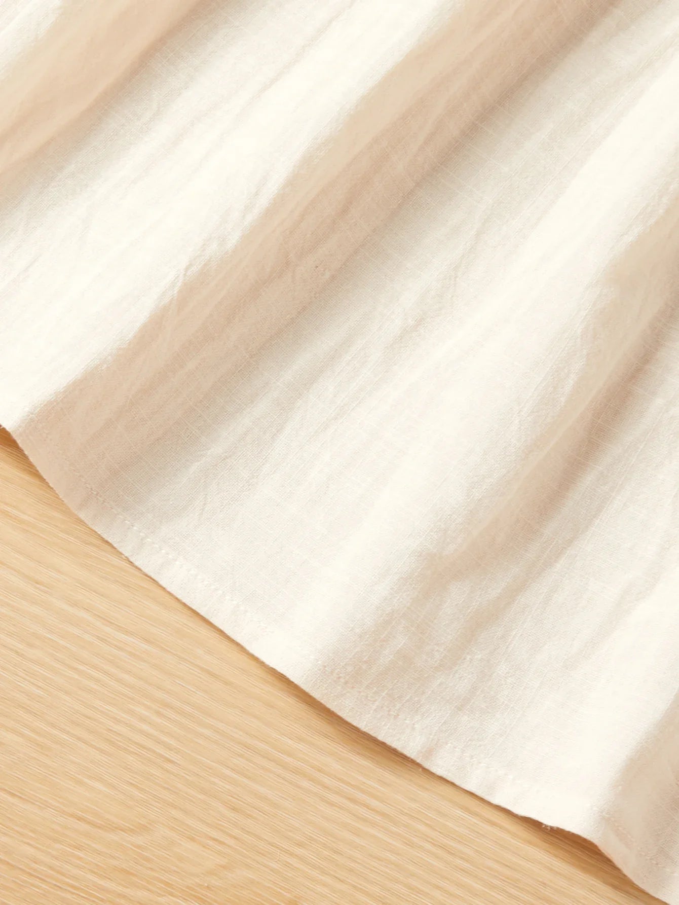 Close-up of the delicate floral embroidery and fabric texture of the dress