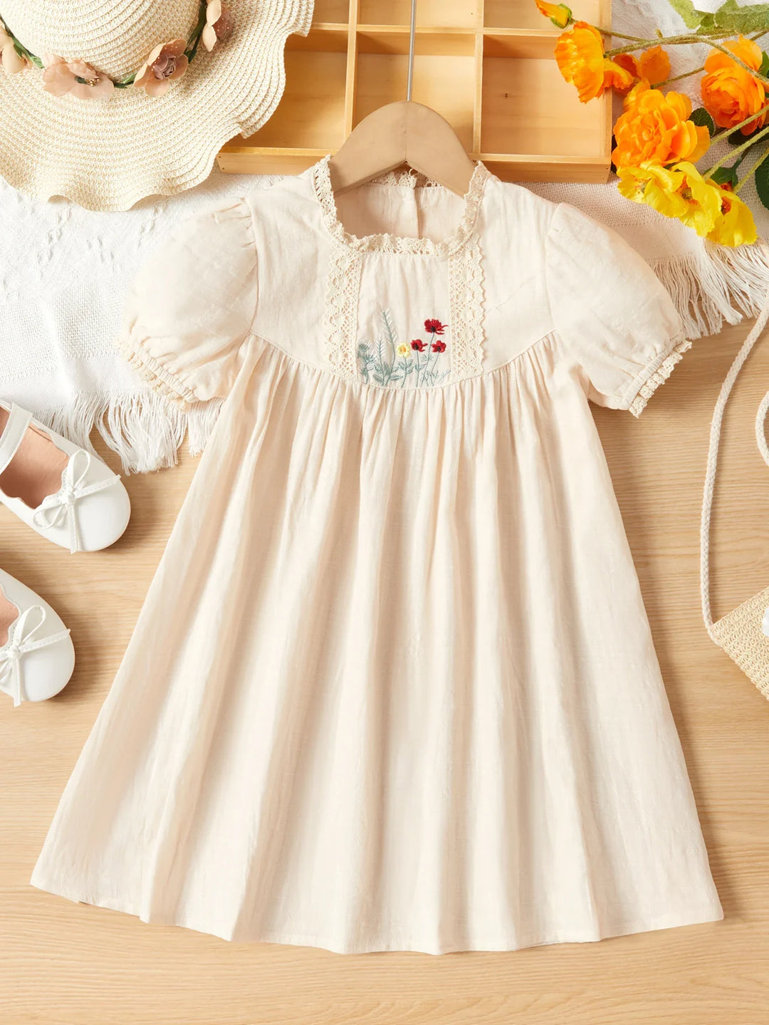 Side view of a happy child in a casual pink floral embroidered princess dress