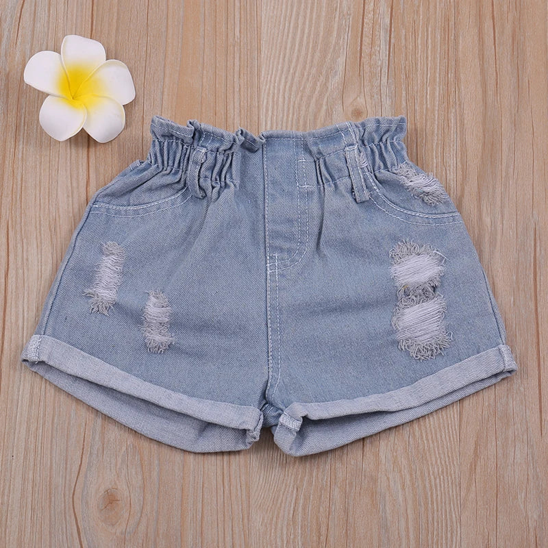 Two-piece girls' outfit: white floral halter top paired with light wash denim shorts