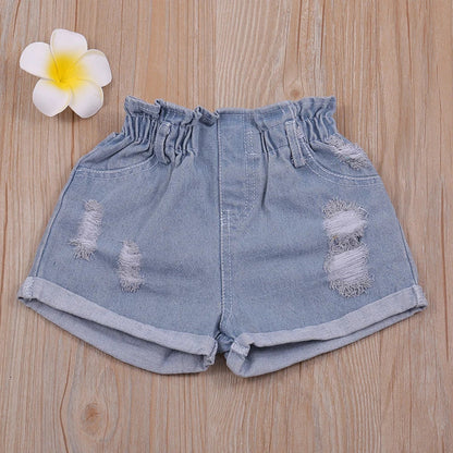 Two-piece girls' outfit: white floral halter top paired with light wash denim shorts