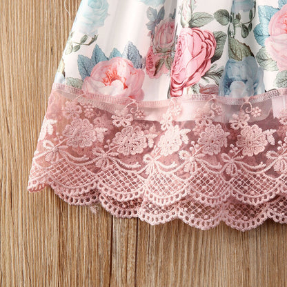 Close-up of bow detail on a floral lace girls' princess dress, highlighting intricate design.