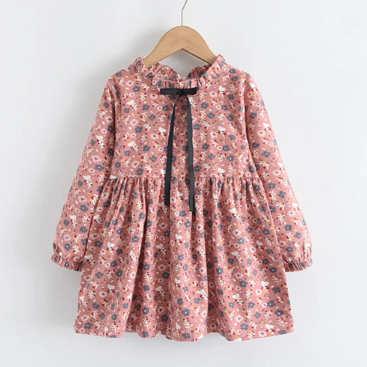 Side view of a Girls Floral Princess Dress, showing the flow of the long sleeve and floral design.