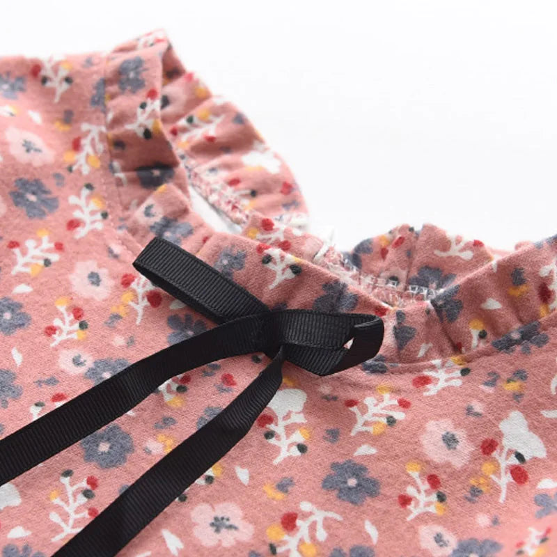 A cute toddler girl happily wearing a long sleeve floral princess dress, suitable for spring autumn.