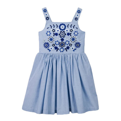 Girls' floral summer dress in a bright setting, emphasizing its playful beach style