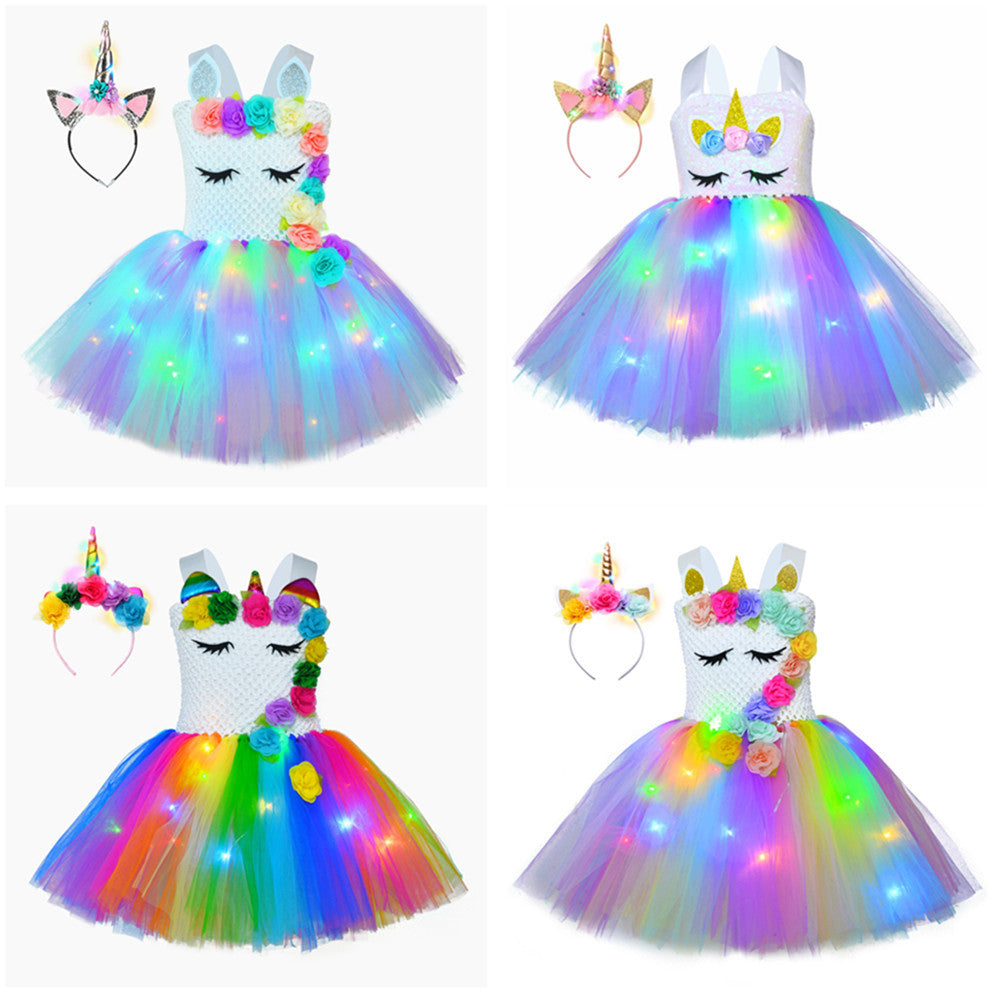 Toddler girl in a vibrant floral unicorn LED tutu dress, featuring a soft crochet top.