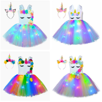 Toddler girl in a vibrant floral unicorn LED tutu dress, featuring a soft crochet top.