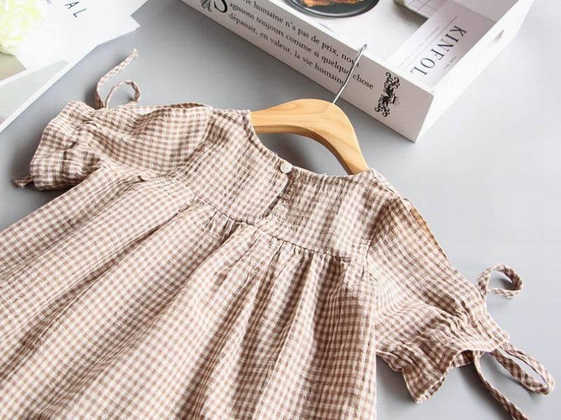 Stylish girls' gingham dress. Classic plaid pattern, comfortable cotton frock for summer playtime and baby girl outfits.