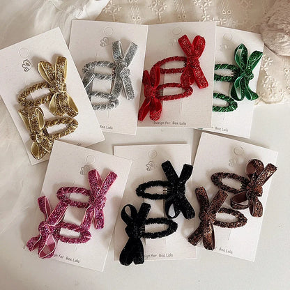 Girls' glitter bow hair clips 2-pack for festive occasion, toddler hair accessory.