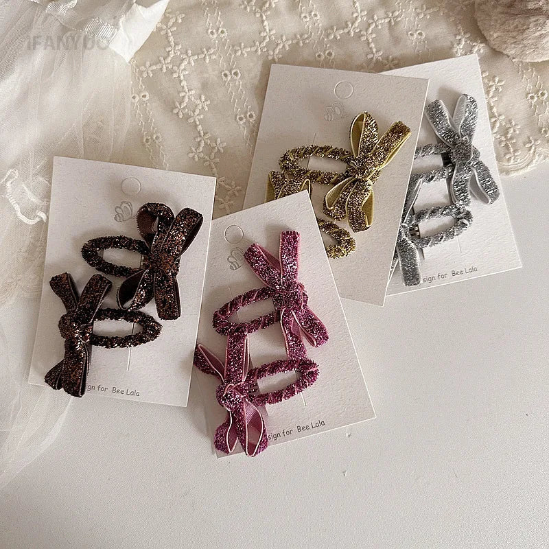 Two festive glitter hair bows for children, excellent for styling girls' hair.