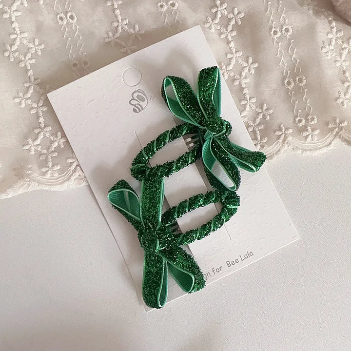 Shimmering bow hairpins for toddlers, an adorable addition to any young girl's look.