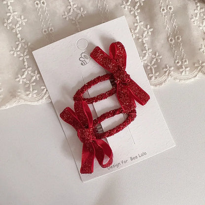 Girls' fashion hair clips featuring glitter bows, suitable for all festive styles.