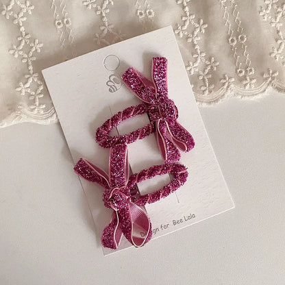 Set of two glitter hair accessories for kids, easy to clip into little girls' hair.