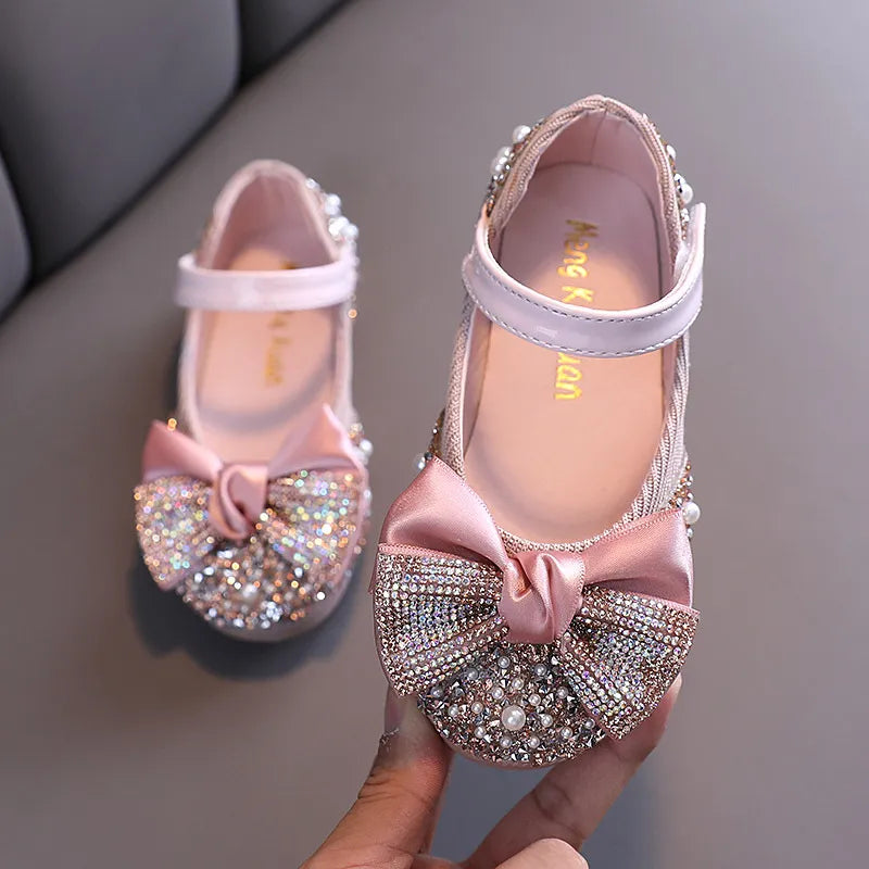 Girls' glittery pink princess party flats with rhinestone bow, perfect for special occasions