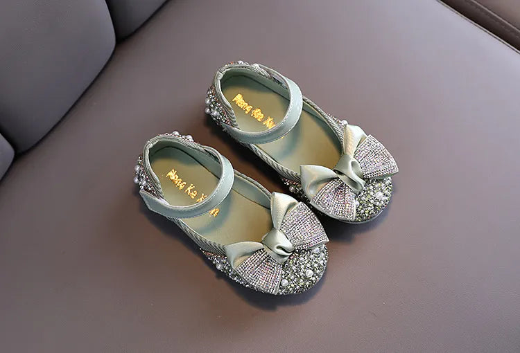 Girls' pink dance flats with a secure and sparkling rhinestone bow, for graceful movement