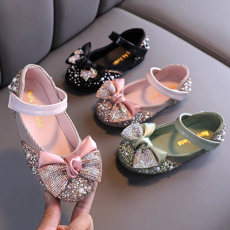 Close-up of rhinestone bow on girls' pink party flats, ideal for dancing and events