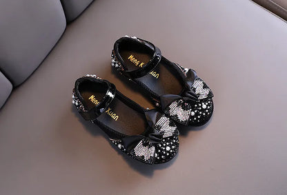 Girls' comfortable yet stylish pink party flats, adorned with a lovely rhinestone bow