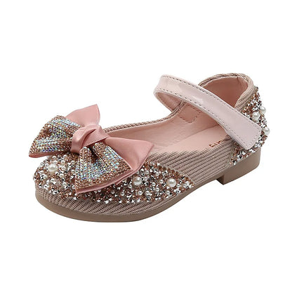 Girls' pink dance flats with elegant rhinestone bow, perfect for parties and special events