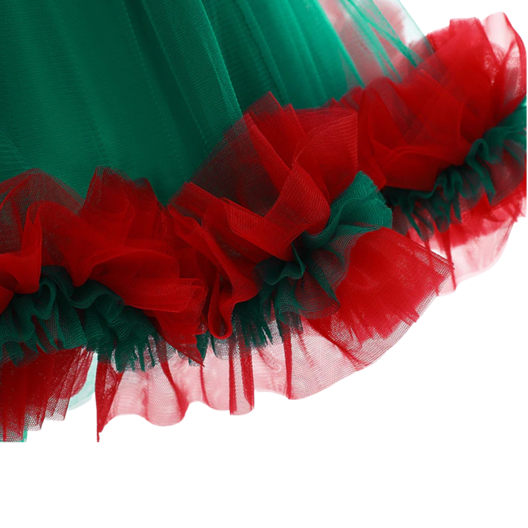 Close-up of a girl's green sequin top and ruffled tulle skirt princess dress.