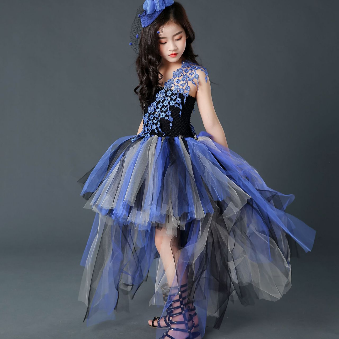 Close-up of a girl's Halloween tutu dress with black bodice and purple trailing skirt layers, fancy dress