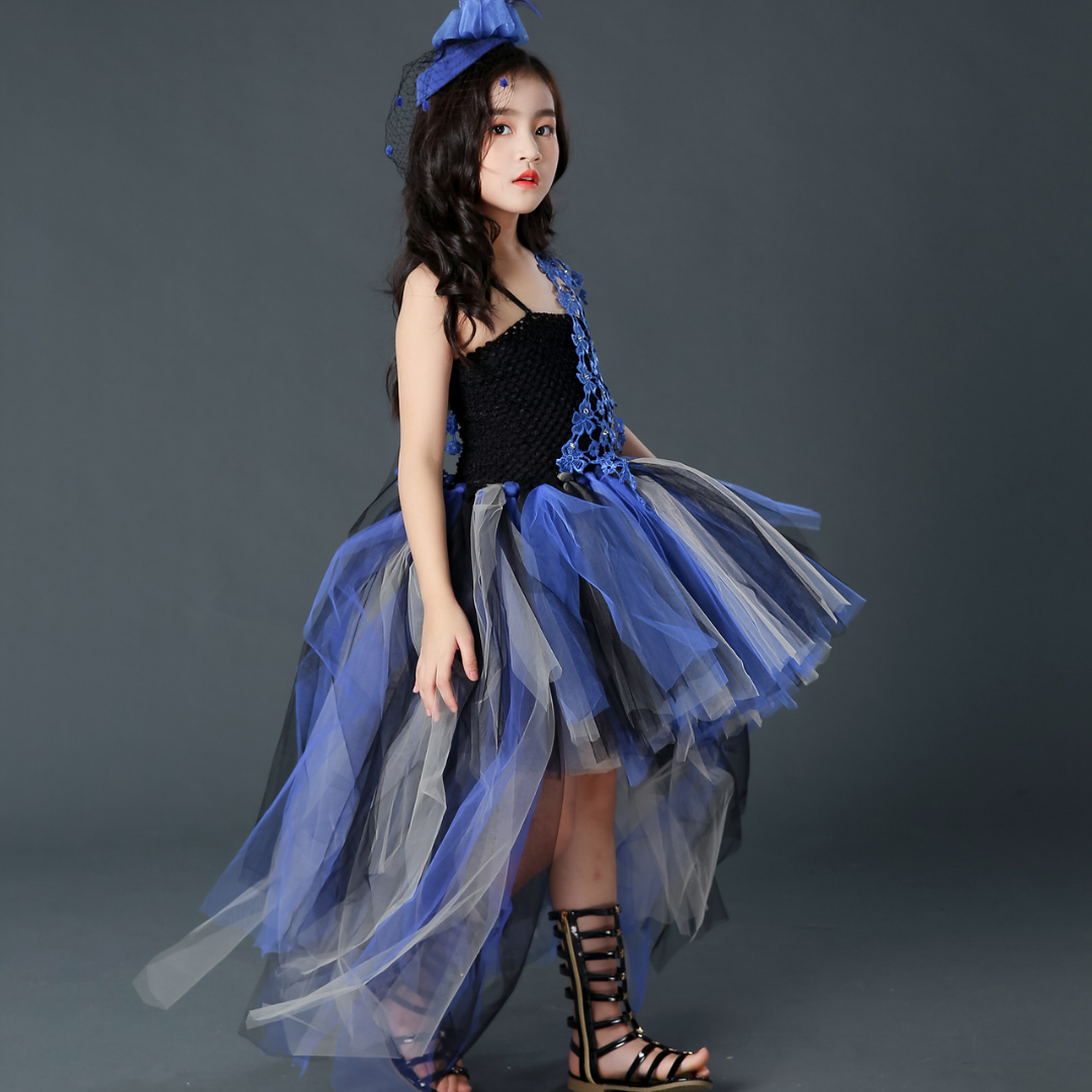 Detailed view of the purple trailing tutu skirt of a black sleeveless Halloween party dress for girls