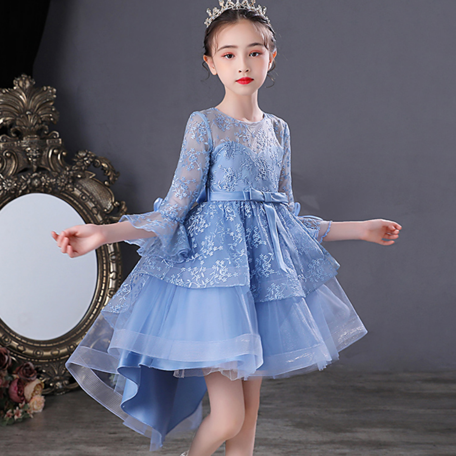 Young girl happily twirling in a sleeveless jacquard mesh bow princess party dress.