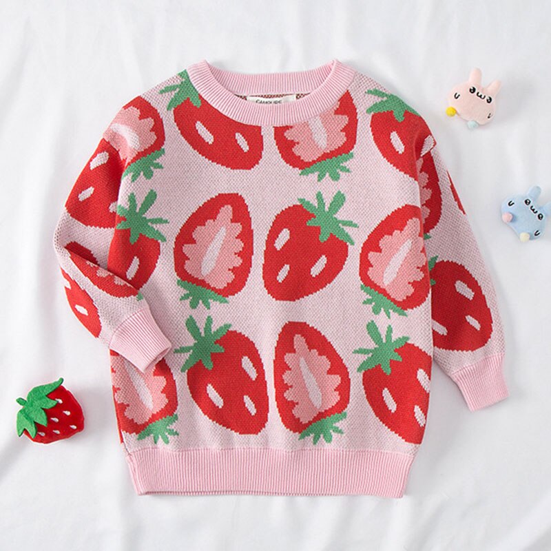 Close-up of the buttons and pear fruit pattern on a pink girls' knitted cotton sweater, soft and warm.