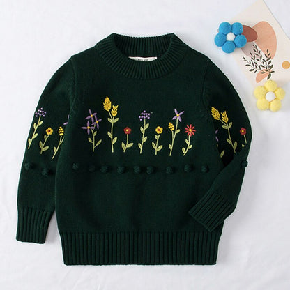 Front view of a baby girl's pink knitted cardigan sweater, highlighting the delightful pear fruit pattern.