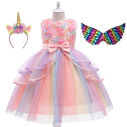 Close-up of the iridescent unicorn wings, showing their delicate construction and attachment to the dress.