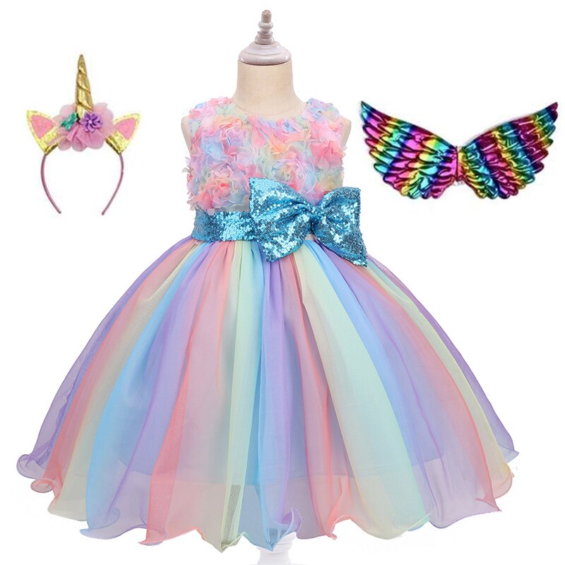 Happy child twirling in a beautiful, multilayered unicorn party dress, ready for a special occasion.