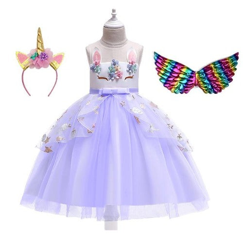 Close-up of the bodice of a girls' unicorn dress, featuring colorful floral appliques and a glittery design.