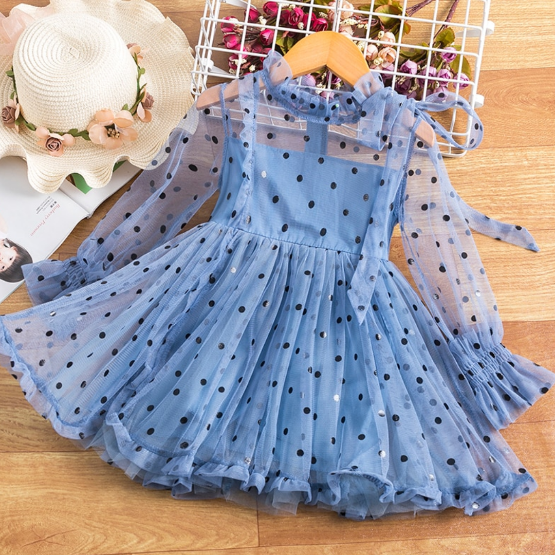 Toddler girl in elegant long sleeve dotted mesh ruffled dress, perfect for photos.