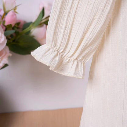 Girls' long sleeve princess dress with a simple yet elegant ruffled design for spring.