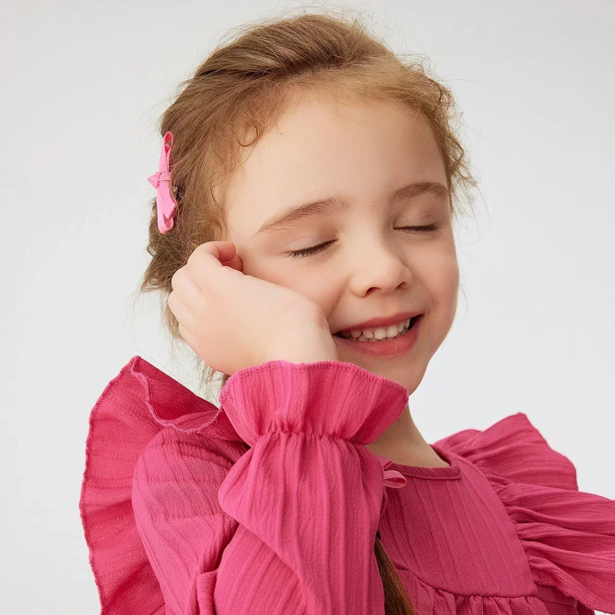 Close-up of the delicate ruffle detail on a girls' long sleeve princess dress for parties.