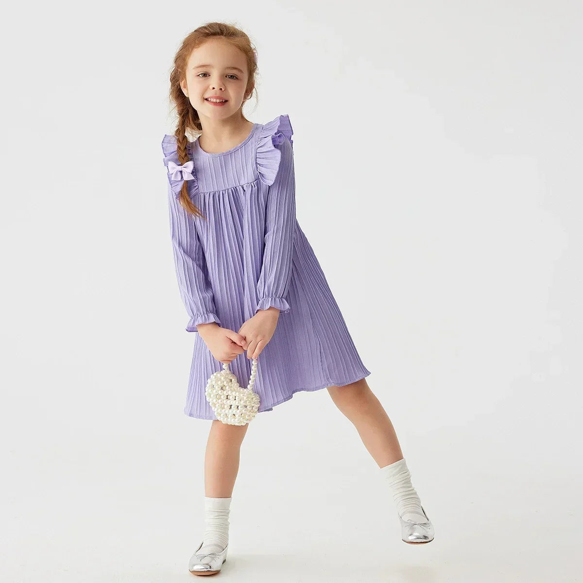 Toddler girl wearing a charming long sleeve ruffled princess dress, ideal for spring casual wear.