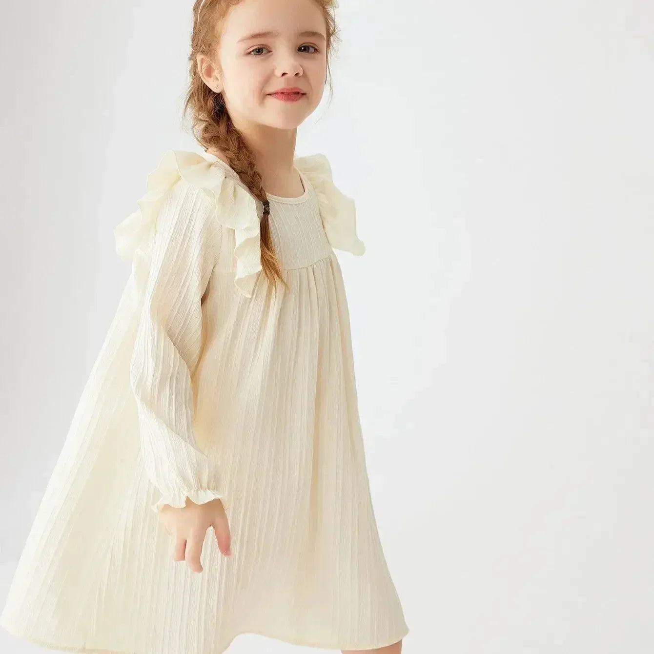 Full shot of a girls' pink long sleeve A-line princess dress with ruffles, children's wear.