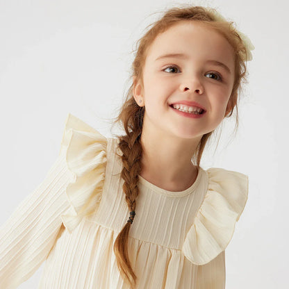 Happy toddler girl in a comfortable long sleeve ruffled princess dress, perfect for spring.