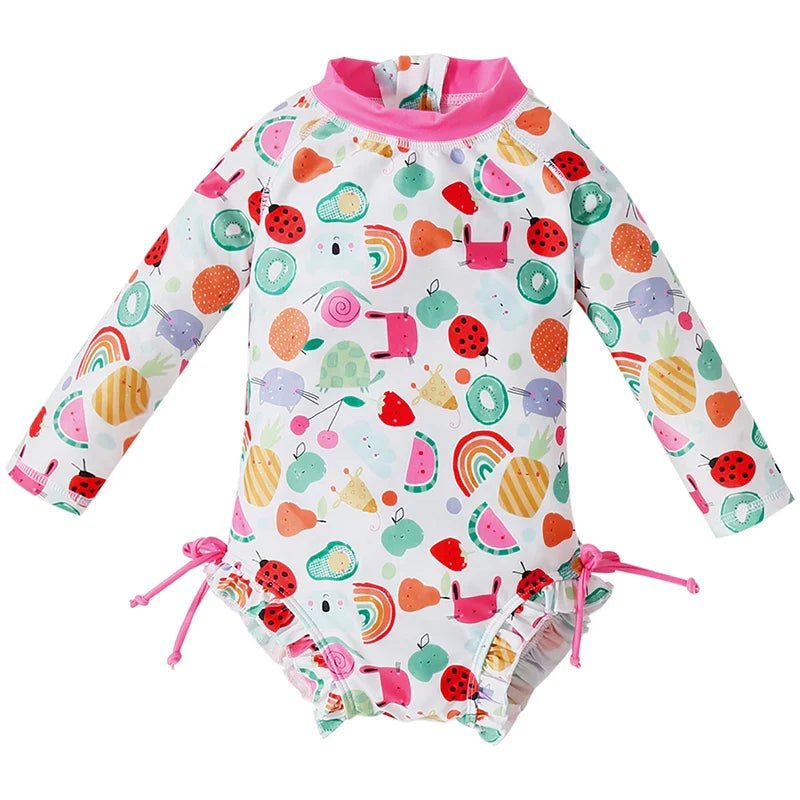 Girls' long sleeve UV protect swimsuit with playful seashell print for beach or pool.