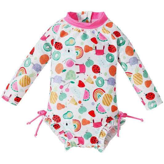 Girls' long sleeve UV protect swimsuit with playful seashell print for beach or pool.