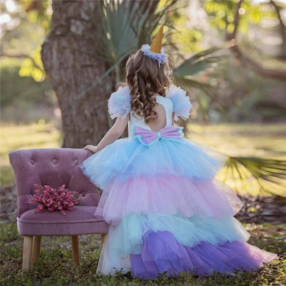 Toddler girl wearing a vibrant unicorn princess dress with sheer wings & fluffy long back skirt