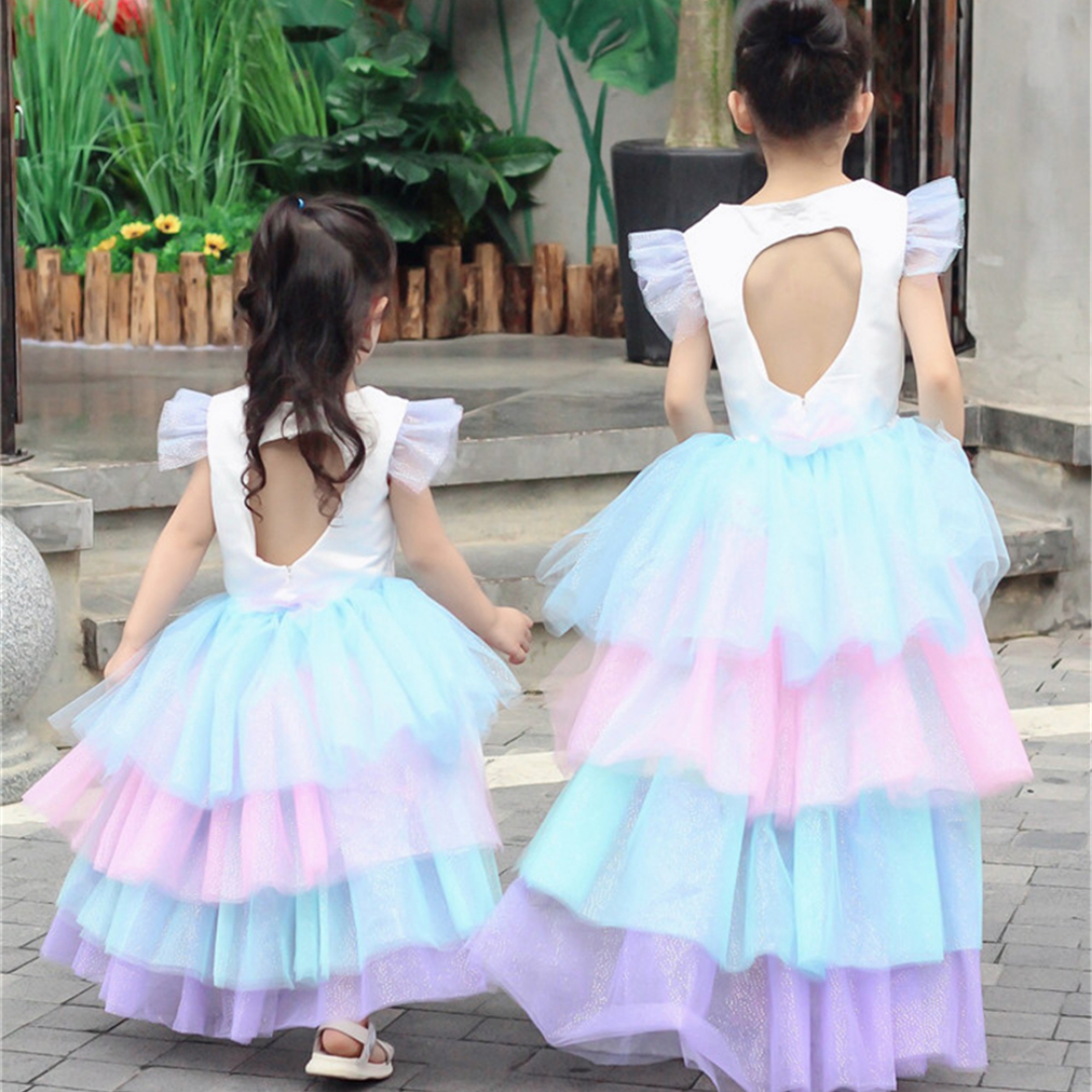 Back view of a girls' unicorn princess dress showcasing its large, flowing wings and long, colorful skirt