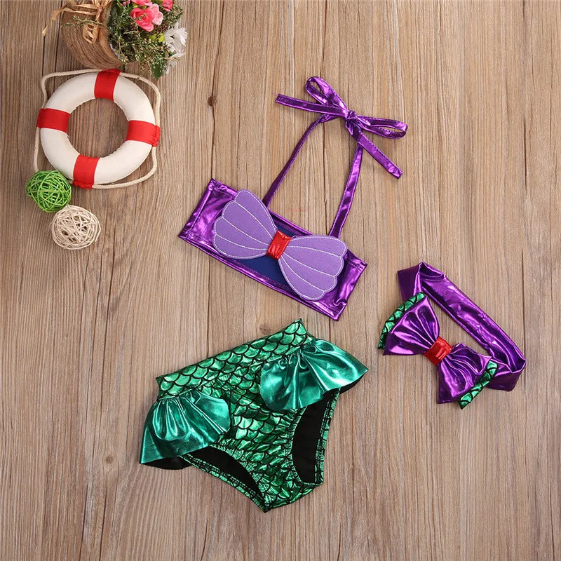 Front view of girls' mermaid swimsuit with purple halter top, green high-waist bottoms & headband