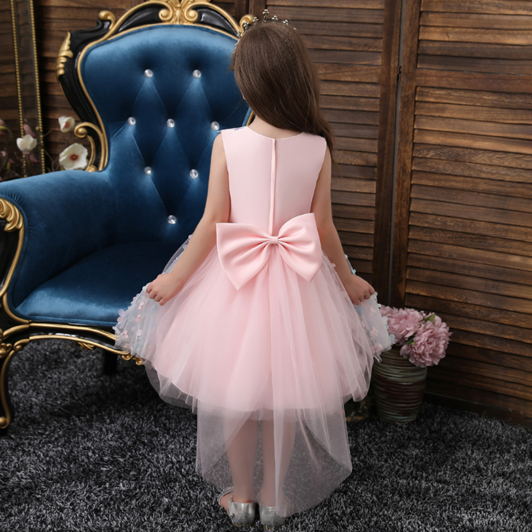 Close-up of a toddler girl's ombre floral dress with delicate pearl details, princess style