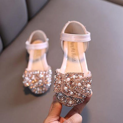 Close-up of girls' dress shoes with pearl & rhinestone accents, open side, perfect for parties