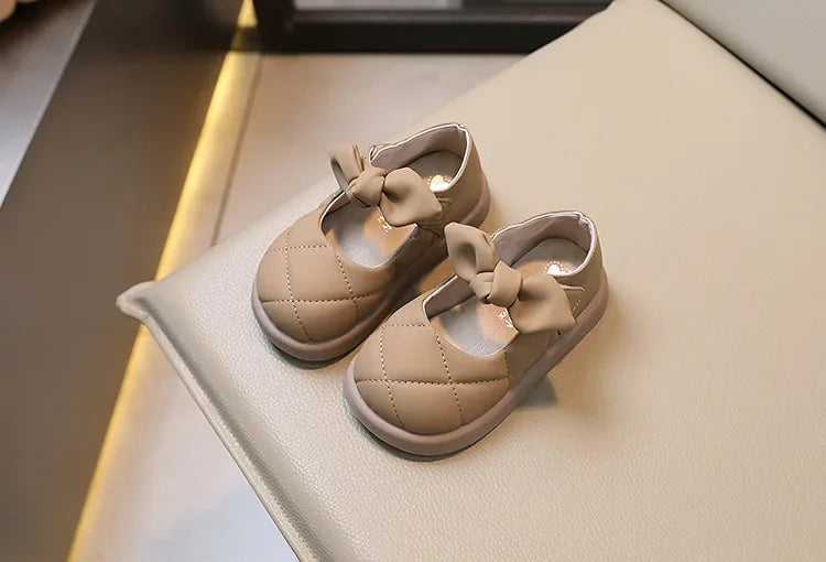 Toddler girl’s foot in pink bowknot leather Mary Janes, comfortable and cute kids' footwear