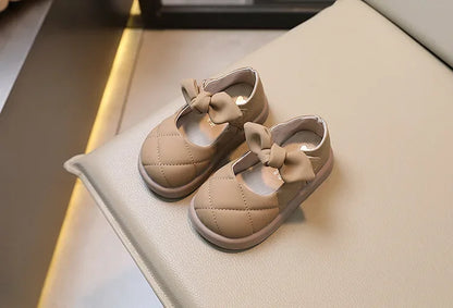 Toddler girl’s foot in pink bowknot leather Mary Janes, comfortable and cute kids' footwear