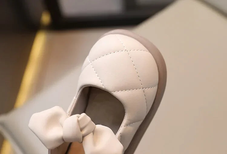 Child playing while wearing comfortable pink bowknot leather Mary Janes, perfect for active girls