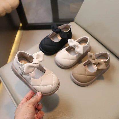 Toddler girl wearing pink bowknot Mary Janes, showcasing comfortable and stylish spring footwear
