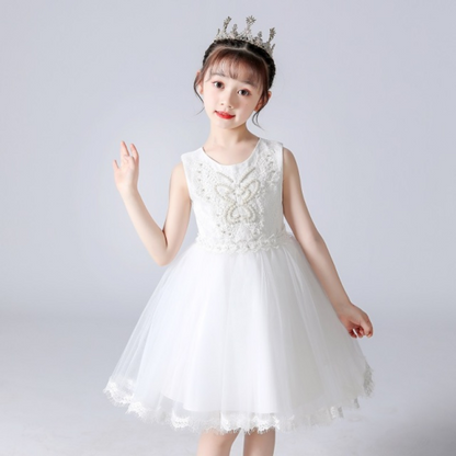 Close-up of pearl and rhinestone details on a girls lace princess party dress with butterfly accents.